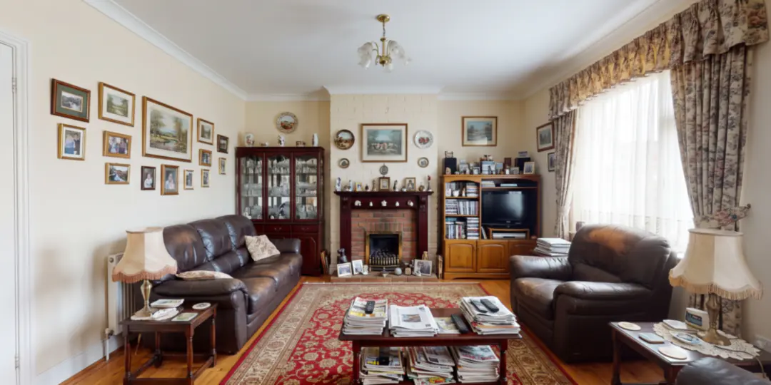 Before: A dated living room crowded with a leather sofa and armchair, a display cabinet, framed pictures and floral curtains